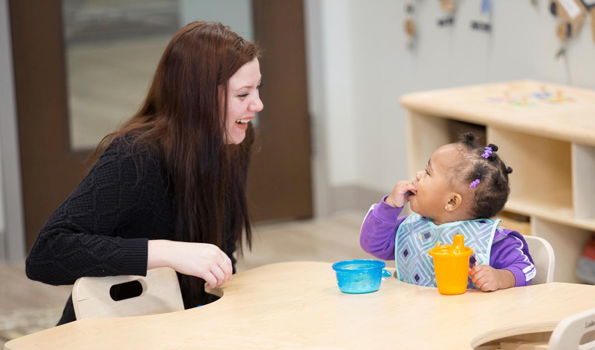 A student at Educare Flint enjoys a snack and a smile.Photo: Rick Smith